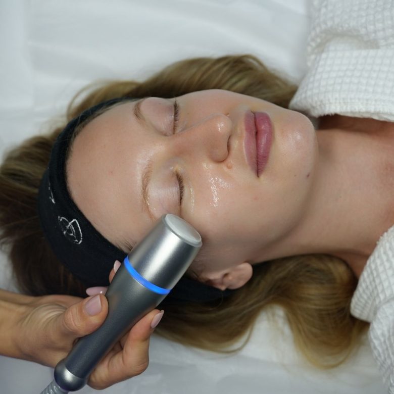 A Cool Restore cryo treatment being applied to a client's face at Skin Restore, San Clemente
